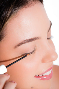 Image of a woman applying Lash Revival Serum from Lash Accents. She delicately applies the serum to her lashes for natural enhancement. Elevate your lash care routine with botanical goodness - Biotin, Ginseng, Pumpkin Seed Extract. Cruelty-free, hypoallergenic, and dermatologically tested for healthy, lush lashes