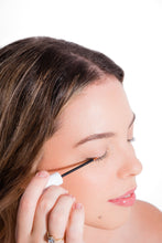 Load image into Gallery viewer, Image of a woman applying Lash Revival Serum from Lash Accents. She delicately applies the serum to her lashes for natural enhancement. Elevate your lash care routine with botanical goodness - Biotin, Ginseng, Pumpkin Seed Extract. Cruelty-free, hypoallergenic, and dermatologically tested for healthy, lush lashes
